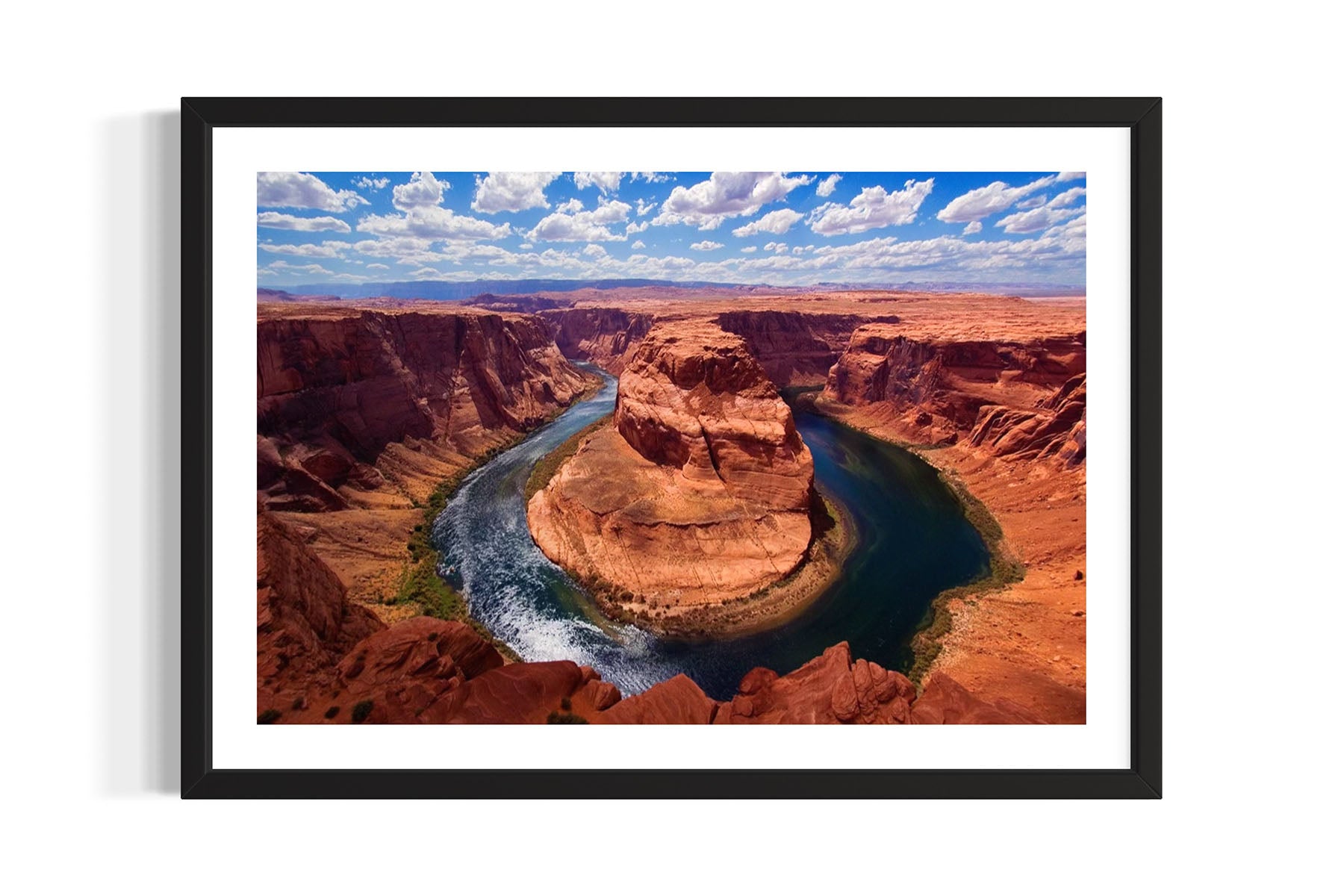 Framed aerial photograph of Horseshoe Bend in Page, AZ with a river cutting through red rock formations by Evan Reinheimer.