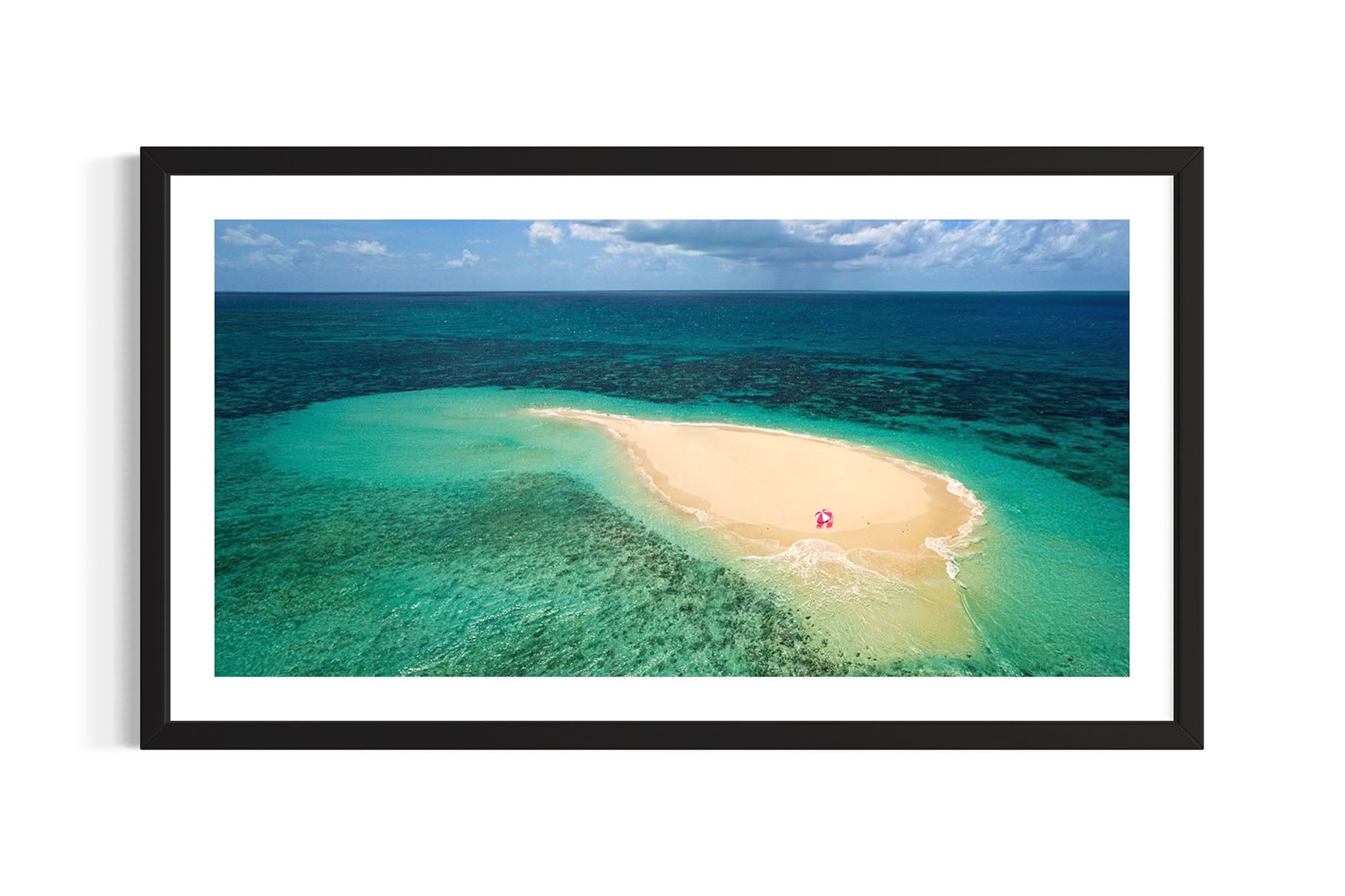 Framed aerial photograph of tropical island Vlasoff Cay, Australia with clear blue water and white sand by Evan Reinheimer.