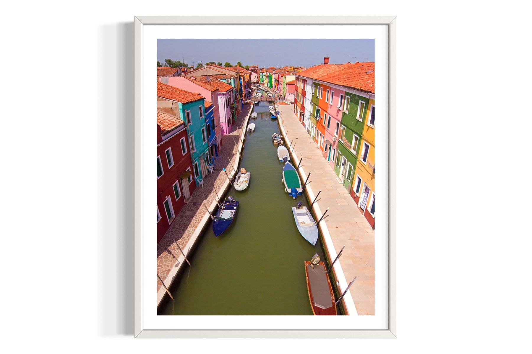 Framed aerial photograph of a colorful canal scene with boats in Burano, Venice, Italy by Evan Reinheimer.