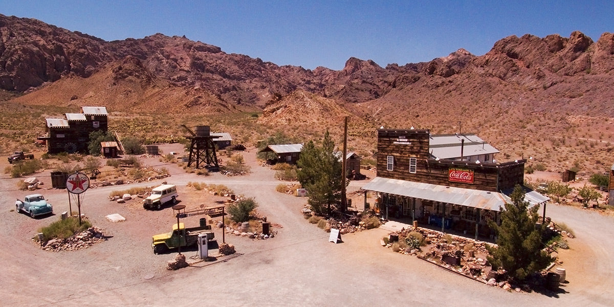 Aerial photograph of a desert landscape with buildings and vehicles in Nelson, Nevada by Evan Reinheimer.