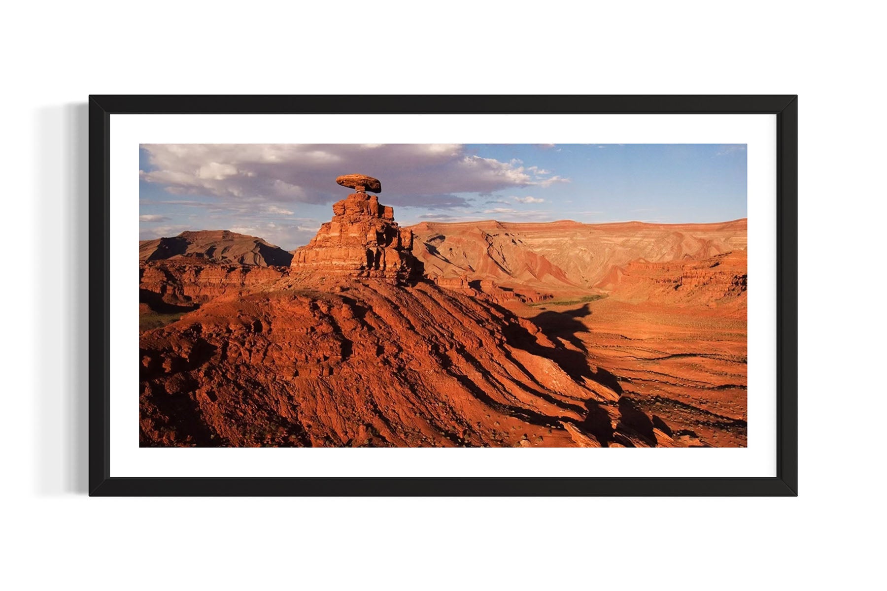 Framed aerial photograph of the Mexican Hat Rock and desert landscape in Utah by Evan Reinheimer.