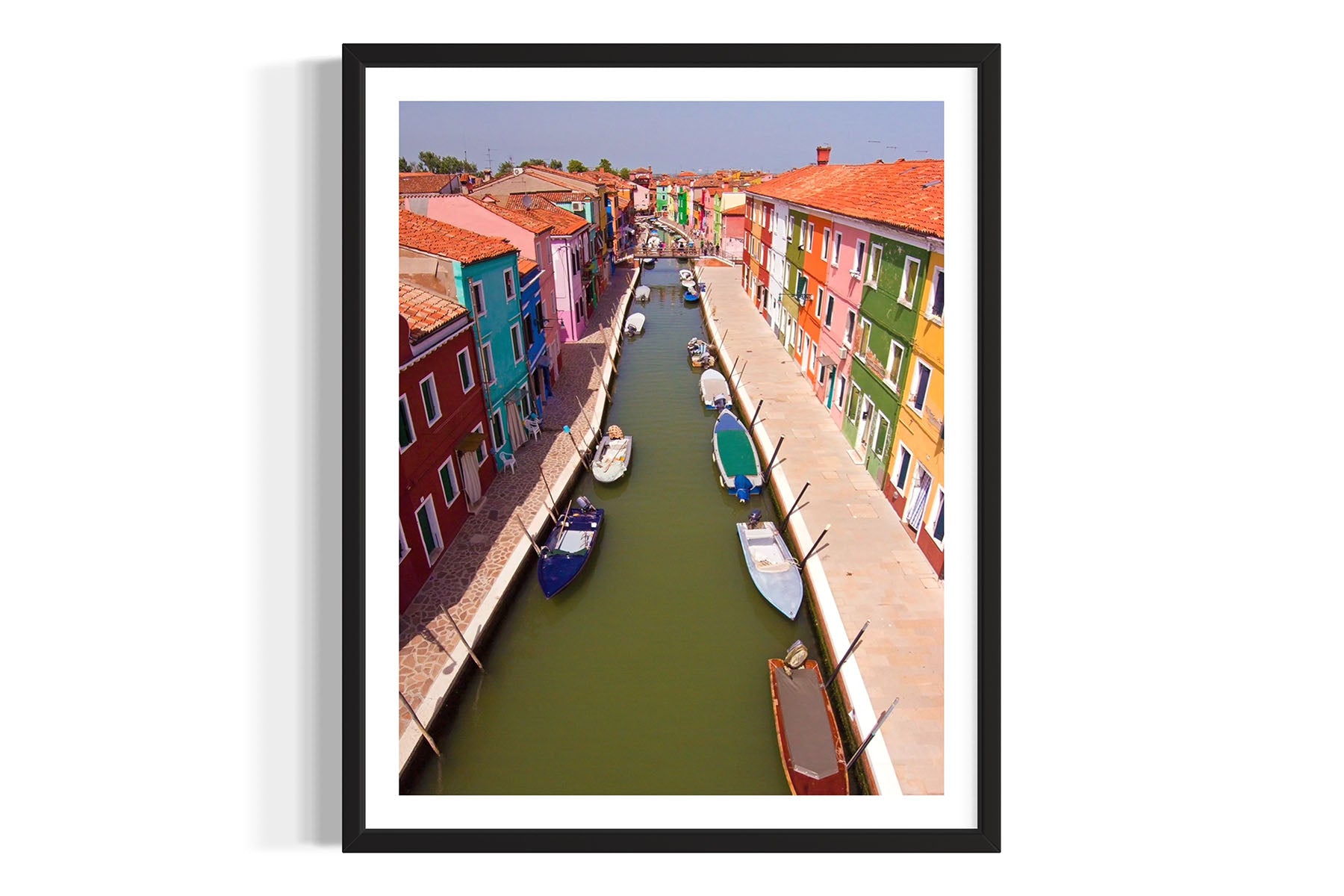 Framed aerial photograph of a colorful canal scene with boats in Burano, Venice, Italy by Evan Reinheimer.
