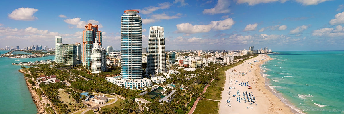 Aerial panoramic photo of Miami Beach, Florida with skyscrapers and beach by Evan Reinheimer.